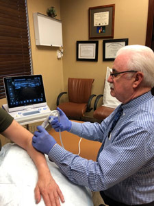 Dr. Fred performing Ultrasound on Patient